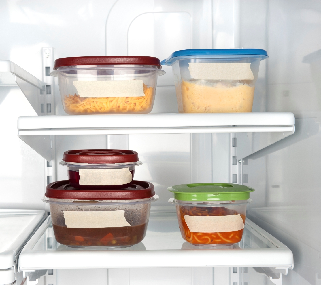 Leftovers in a refrigerator with blank tape for copy.